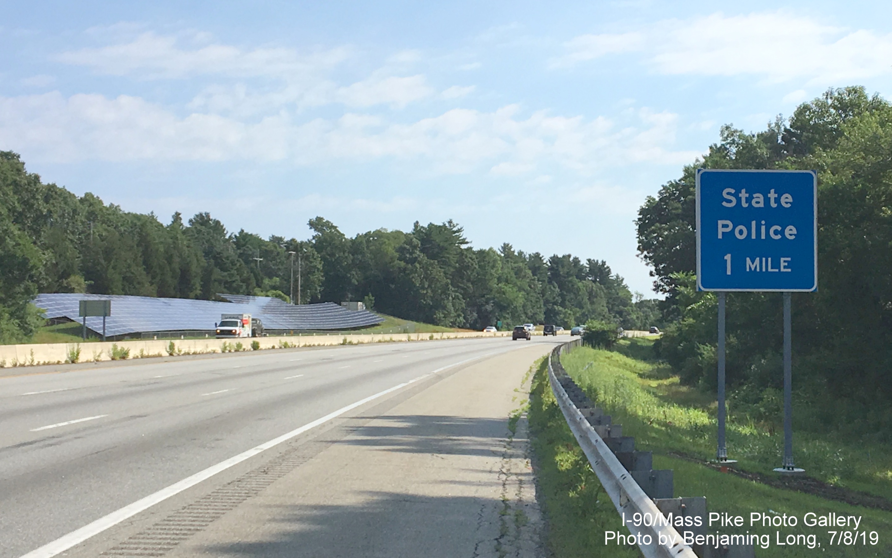 Image of recently placed blue 1-mile advisory sign for State Police Barracks on I-90/Mass Pike East in Natick, by Benjamin Long