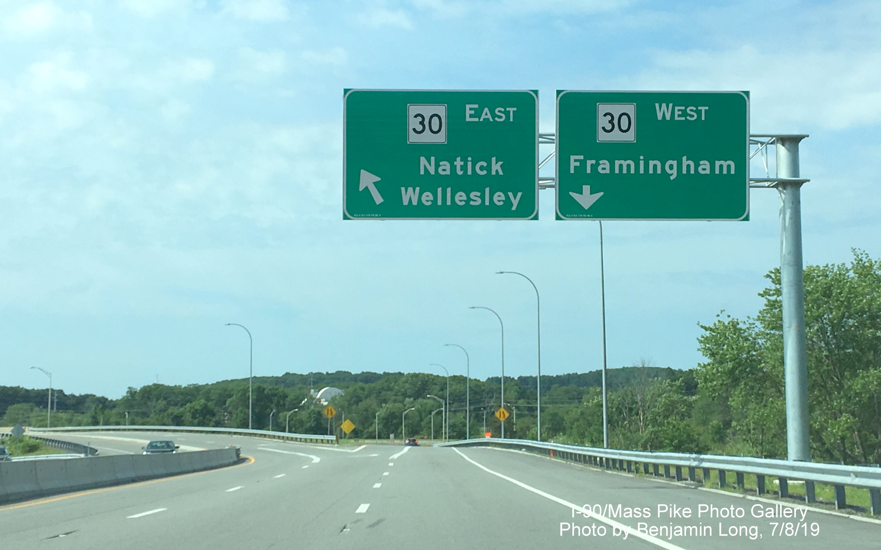 Image of recently placed two overhead signs on cantilever post for MA 30 exit ramps on 
                                                   ramp from I-90/Mass Pike West, by Benjamin Long