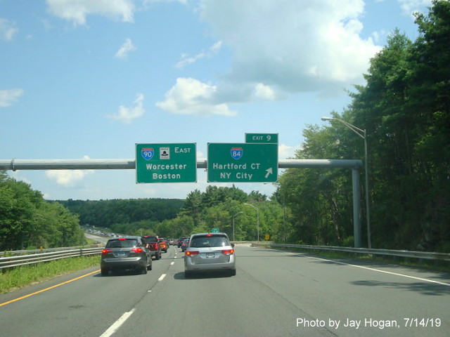 Image of overhead signs at ramp to I-84 (West) on I-90/Mass Pike East in Sturbridge, by Jay Hogan