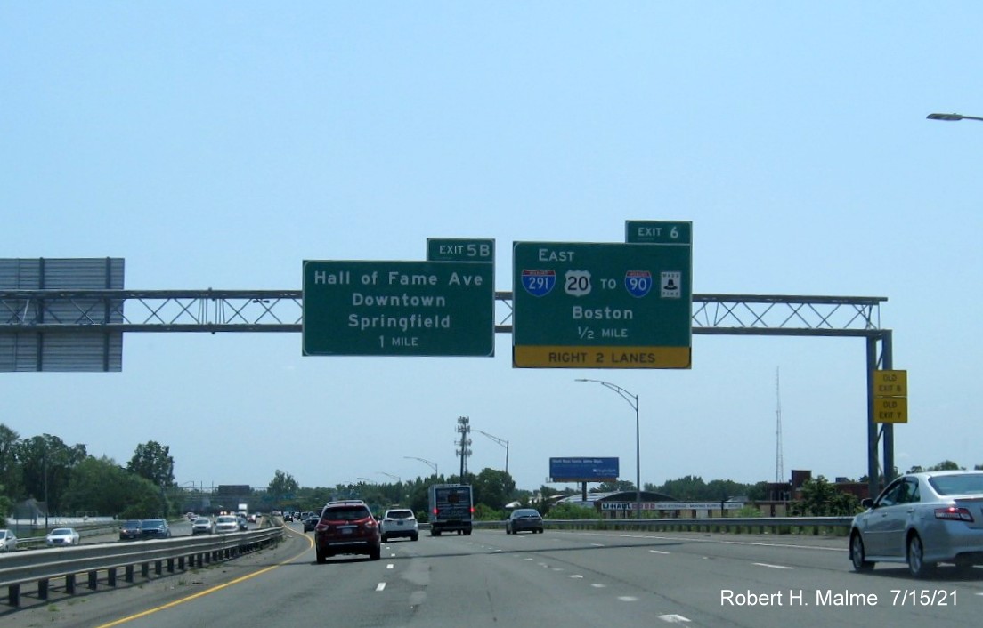 Image of 1/2 mile advance overhead sign with new milepost based exit number for I-291/US 20 East exit with Old Exit 8 sign on right support on I-91 South in West Springfield, July 2021