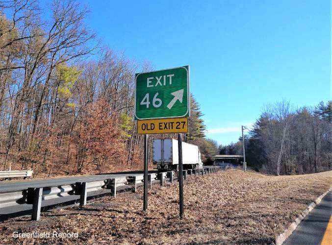 Image of gore sign for MA 2 East exit with new milepost based exit number and yellow Old Exit 27 sign attached below, by Greenfield Record, March 2021