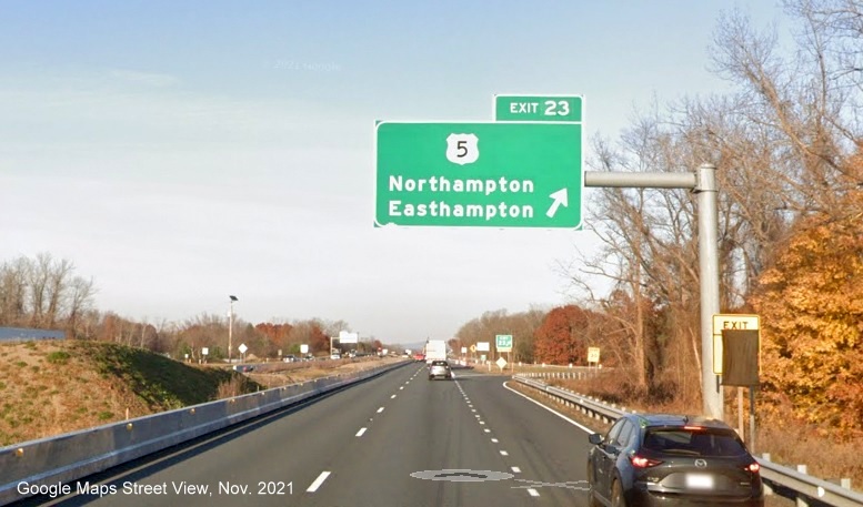 Image of overhead ramp sign for US 5 exit with new milepost based exit number and new gore sign with yellow Old Exit 18 sign attached below on I-91 North in Northampton, Google Maps Street View image, November 2021