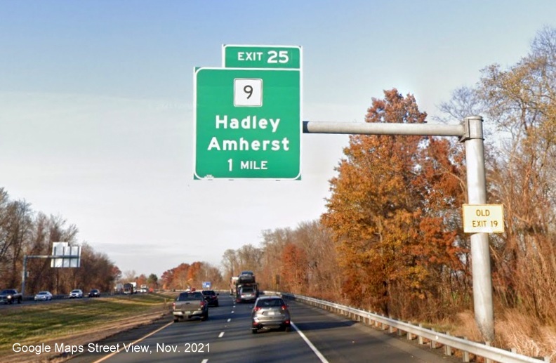 Image of 1 mile advance overhead sign for MA 9 exit with new milepost based exit number and yellow Old Exit 19 advisory sign on support on I-91 North in Amherst, Google Maps Street View image, November 2021