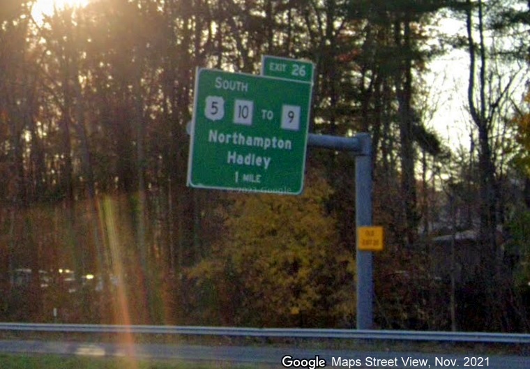 Image of 1 mile advance overhead sign for South US 5/MA 10 to MA 9 exit with new milepost based exit number and yellow Old Exit 20 advisory sign on support on I-91 South in Amherst, Google Maps Street View image, November 2021