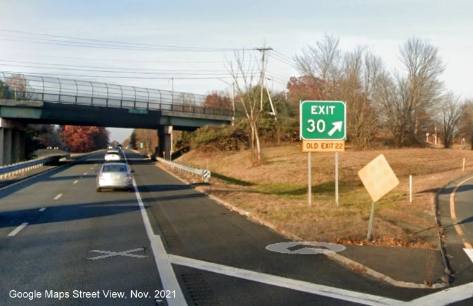 Image of gore sign for US 5/MA 10 exit with new milepost based exit number and yellow Old Exit 22 sign attached below on I-91 North in Whately, Google Maps Street View image, November 2021