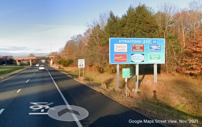 Image of blue Attractions sign for US 5/MA 10 to MA 116 exit with new milepost based exit number on I-91 North in Deerfield, Google Maps Street View image, November 2021