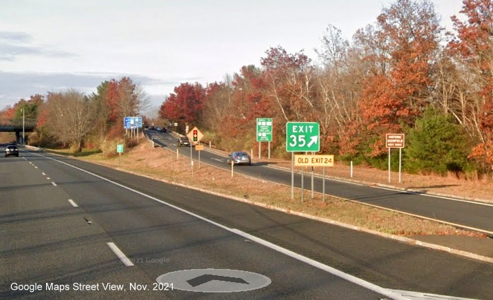 Image of gore sign for US 5/MA 10 to MA 116 exit with new milepost based exit number and yellow Old Exit 24 sign attached below on I-91 North in Deerfield, Google Maps Street View image, November 2021