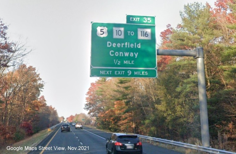 Image of 1/2 mile advance overhead sign for US 5/MA 10 to MA 116 exit with new milepost based exit number on I-91 North in Deerfield, Google Maps Street View image, November 2021