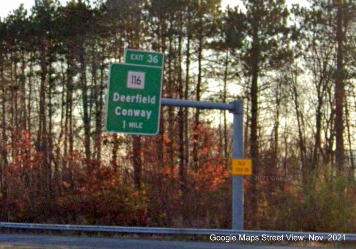 Image of 1 mile advance overhead sign for MA 116 exit with new milepost based exit number and yellow Old Exit 25 advisory sign on support on I-91 South in Deerfield, Google Maps Street View image, November 2021