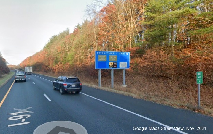 Image of blue attractions sign for West MA 2/East MA 2A exit with new milepost based exit number on I-91 North in Greenfield, Google Maps Street View image, November 2021