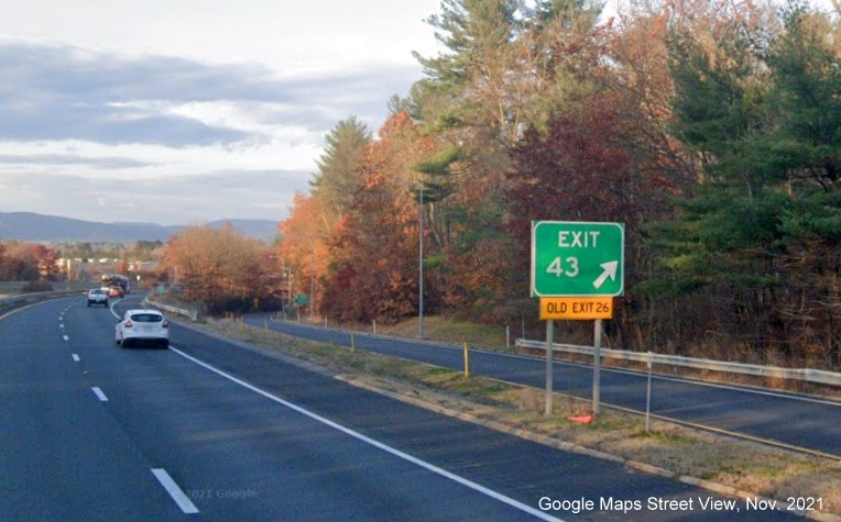 Image of gore sign for West MA 2/East MA 2A exit with new milepost based exit number and yellow Old Exit 26 sign attached below on I-91 North in Greenfield, Google Maps Street View image, November 2021