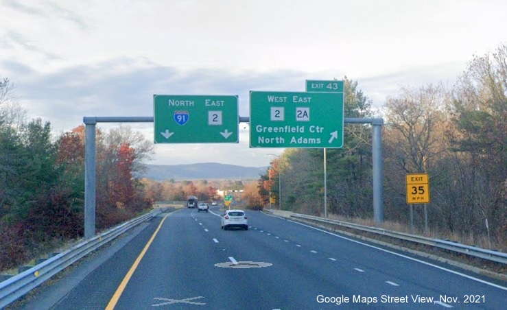 Image of overhead ramp sign for West MA 2/East MA 2A exit with new milepost based exit number on I-91 North in Greenfield, Google Maps Street View image, November 2021