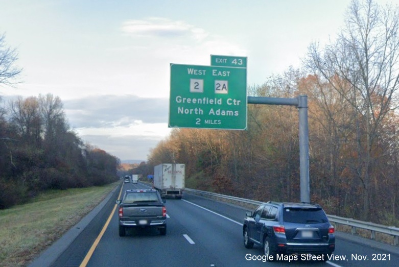 Image of 2 miles advance overhead sign for West MA 2/East MA 2A exit with new milepost based exit number on I-91 North in Greenfield, Google Maps Street View image, November 2021