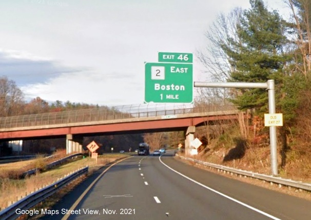 Image of 1 Mile advance overhead sign for MA 2 East exit with new milepost based exit number and yellow Old Exit 27 advisory sign on support on I-91 North in Greenfield, Google Maps Street View image, November 2021