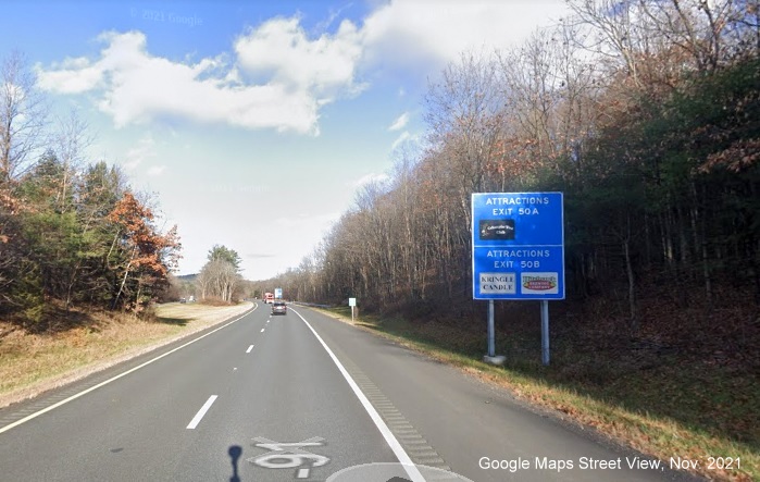 Image of blue Attractions services sign for MA 10 exits with new milepost based exit number on I-91 North in Bernardston, Google Maps Street View image, November 2021 