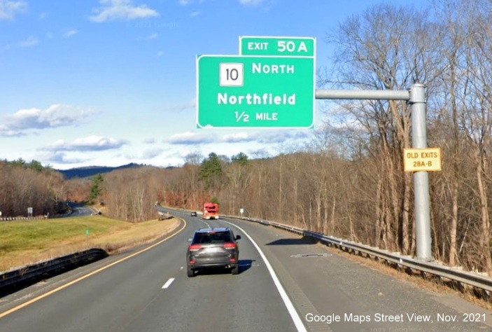 Image of 1/2 Mile advance overhead sign for MA 10 North exit with new milepost based exit number and yellow Old Exits 28 A-B sign on support on I-91 North in Bernardston, Google Maps Street View image, November 2021 