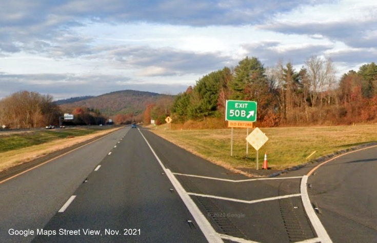 Image of gore sign for MA 10 South exit with new milepost based exit number and yellow Old Exits 28 A-B sign attached below on I-91 North in Bernardston, Google Maps Street View image, November 2021 