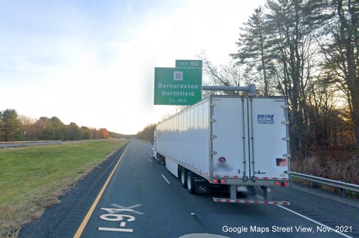 Image of 1/2 Mile advance overhead sign for MA 10 exit with new milepost based exit number and yellow Old Exit 28 sign on support on I-91 South in Bernardston, Google Maps Street View image, November 2021 
