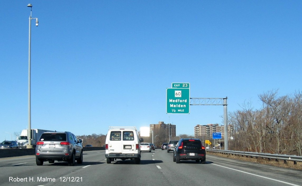 Image of 1/2 mile advance overhead sign for MA 60 exit with new milepost based exit number on I-93 North 
                                          in Medford, December 2021