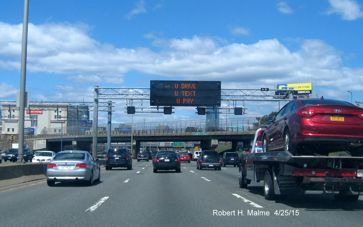 Image of VMS sign with anti-text and drive message on I-93 North in Boston
