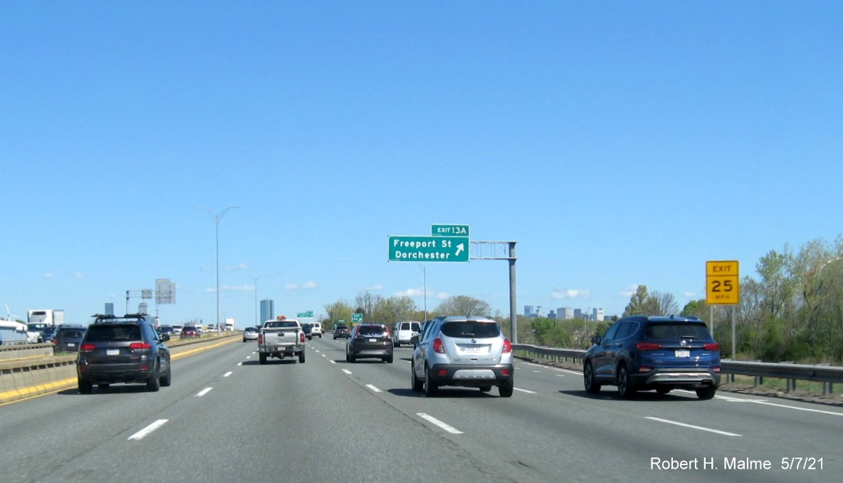 Image of overhead ramp signs for Freeport Street exit with new milepost based exit number on I-93/Southeast Expressway North in Dorchester, May 2021