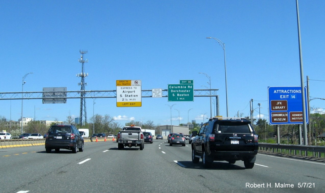 Image of 1 Mile advance sign for Columbia Road exit with new milepost based exit number and hidden yellow Old Exit 15 advisory sign on support post on I-93/Southeast Expressway North in Dorchester, May 2021