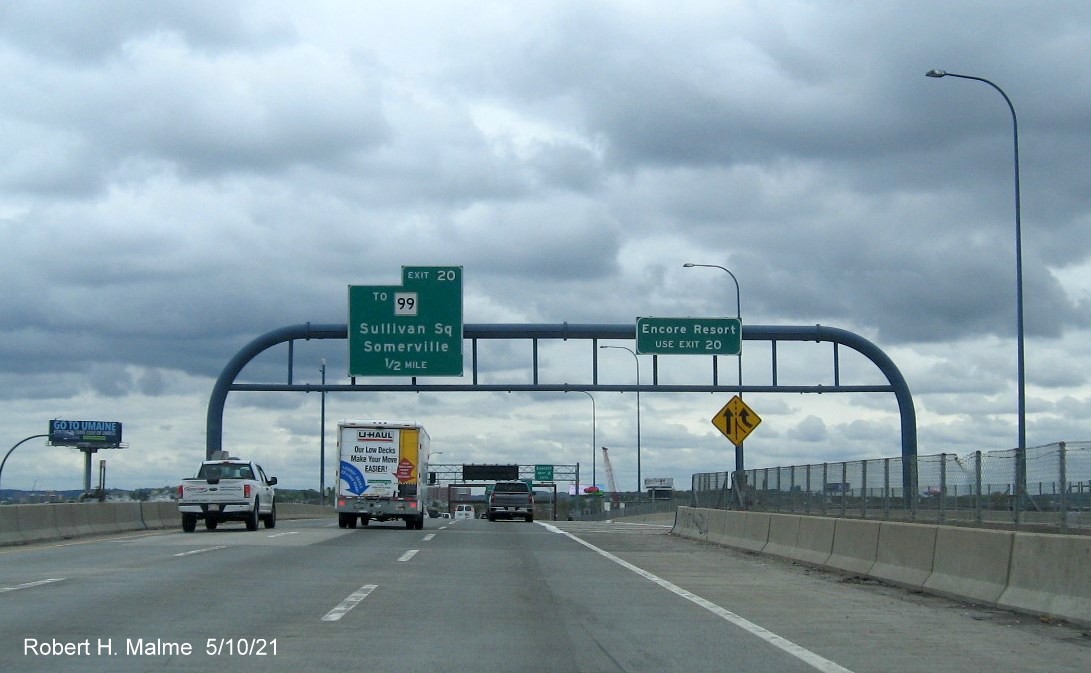 Image of 1/2 mile advance and auxiliary overhead signs for To MA 99 exit with new milepost based exit numbers on I-93 North in 
      Charlestown, May 2021