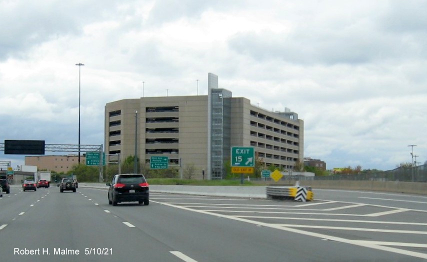 Image of gore sign for Mass Ave exit with new milepost based exit number and yellow Old Exit 18 sign attached below on I-93 South in Boston, May 2021