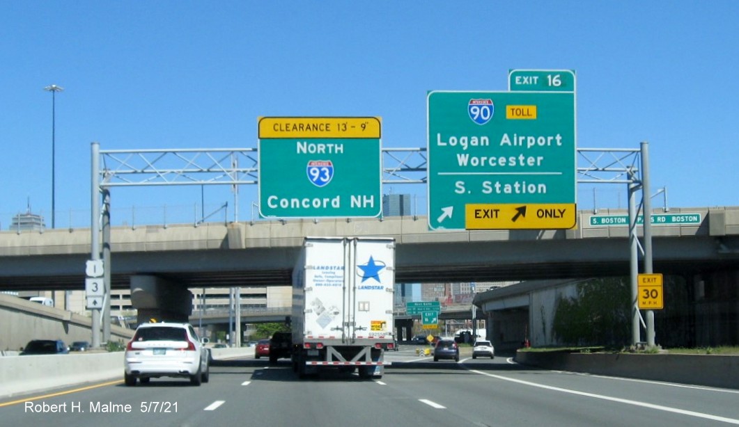 Image of overhead ramp sign for I-90/South Station exit with new milepost based exit number on I-93 North in South Boston, May 2021