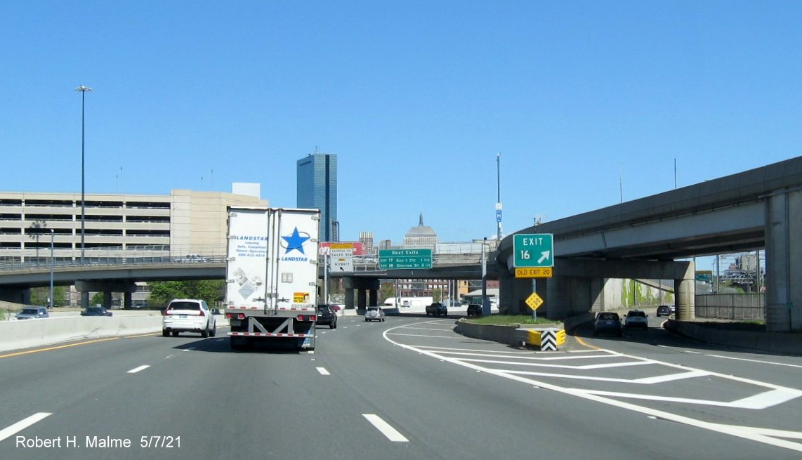 Image of gore sign for I-90/South Station exit with new milepost based exit number and yellow Old Exit 20 sign attached below on I-93 North in South Boston, May 2021