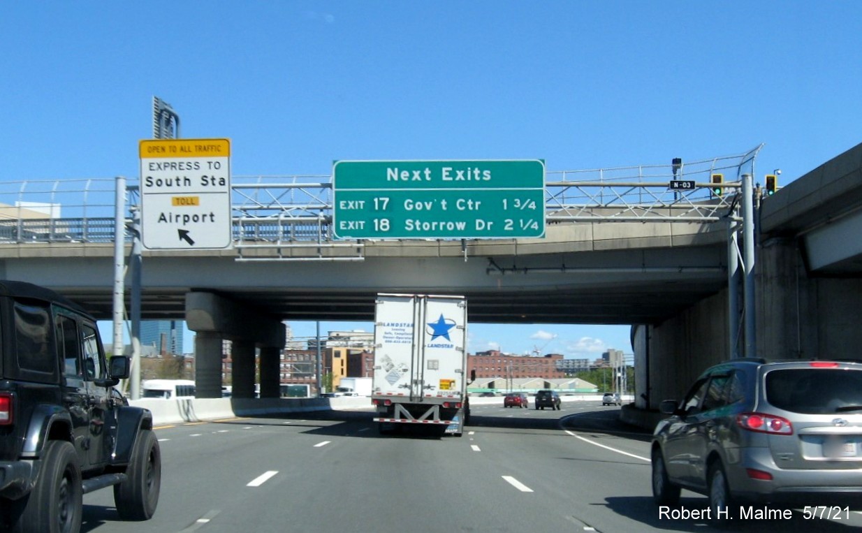 Image of next exits overhead auxiliary sign for Government Center and Storrow Drive exits with new milepost based exit numbers on I-93 North in South Boston, May 2021
