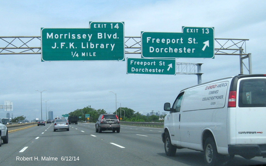 Image of new ramp sign for Exit 13 on I-93 North in Boston, obscured by old signs