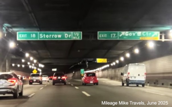 Image of overhead signs at the Government Center exit with 1/2 mile advance for the 
	Storrow Drive exit with new milepost based numbers on I-93 North in Boston, video capture from Mileage Mile Travels, June 2025