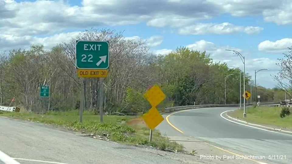 Image of gore sign for MA 16 West exit with new milepost based exit number and yellow Old Exit 31 sign 
                                           attached below on I-93 in Medford, by Paul Schlichtman, May 2021