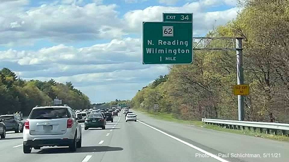 Image of 1 mile advance sign for MA 62 exit with new milepost based exit number and yellow
                                           Old Exit 40 advisory sign on support on I-93 North in Wilmington, by Paul Schlichtman, May 2021