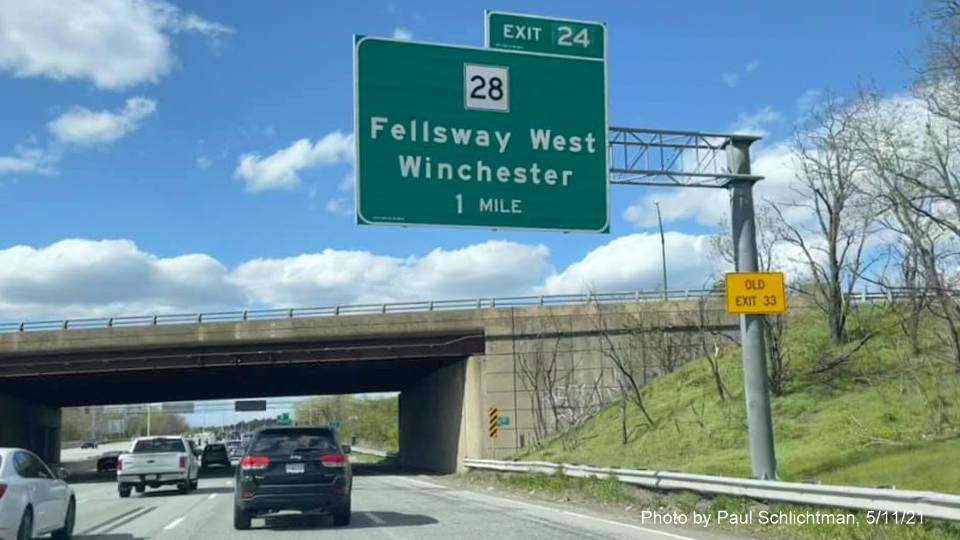 Image of 1 mile advance overhead sign for MA 28 Fellsway exit with new milepost based exit number and yellow Old Exit 33 advisory sign on support on I-93 North in Medford, by Paul Schlichtman, May 2021