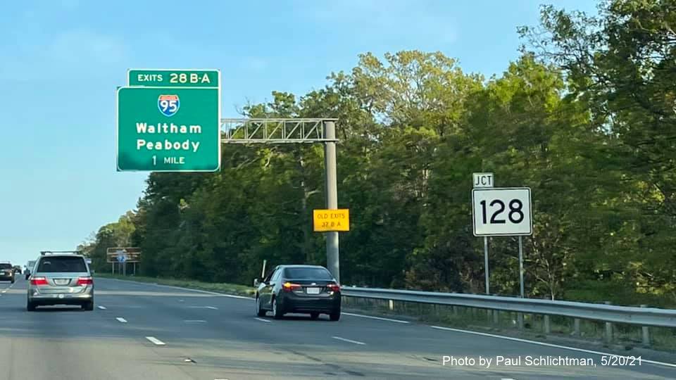 Image of 1 mile advance overhead sign for I-95/MA 128 exits with new milepost based exit numbers and 
                                            yellow Old Exits 37 B-A advisory sign on support on I-93 South in Woburn, by Paul Schlichtman, May 2021