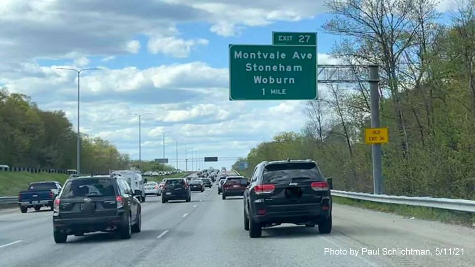 Image of 1 mile advance overhead sign for Montvale Avenue exit with new milepost based exit number and yellow Old Exit 36 advisory sign on support on I-93 North in Stoneham, by Paul Schlichtman, May 2021