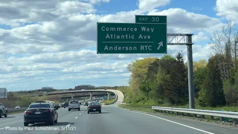 Image of overhead ramp sign for Commerce Way exit with new milepost based exit number on I-93 North in Woburn, by Paul Schlichtman, May 2021