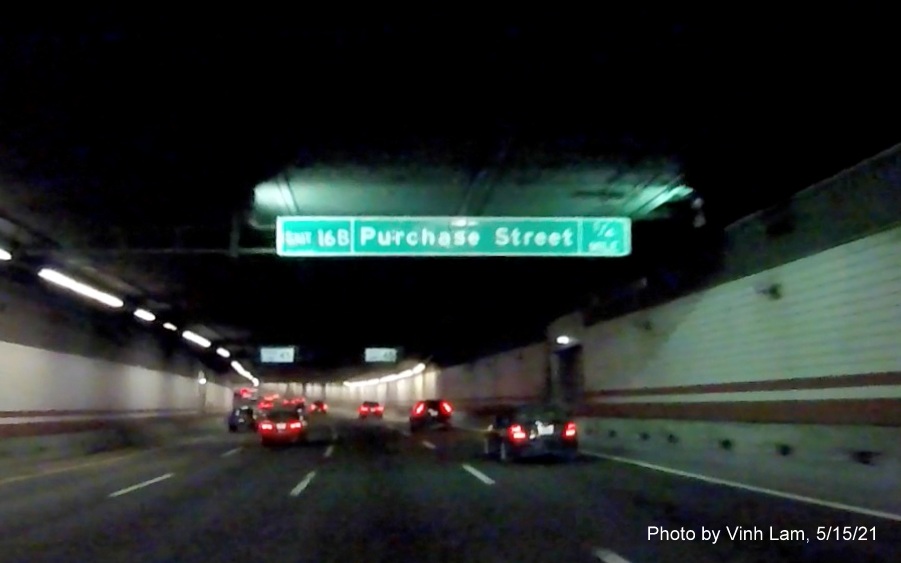 Image of 1/4 mile advance tunnel ceiling mounted sign for Purchase Street exit with new milepost based exit number on I-93 South in Boston, by Vinh Lam, May 2021 