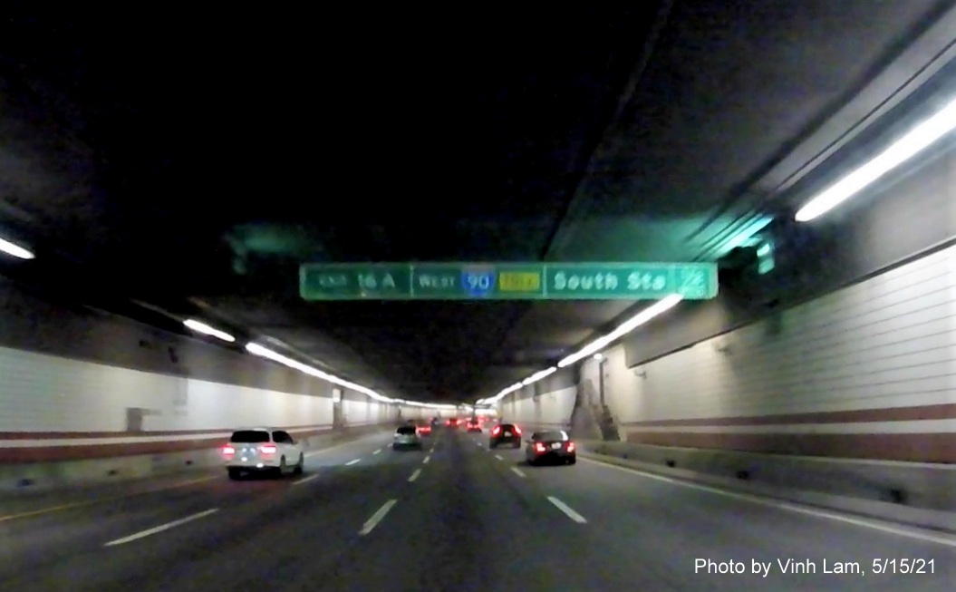 Image of 1/2 mile advance tunnel ceiling mounted sign for I-90/South Station exit with new milepost based exit number on I-93 South in Boston, by Vinh Lam, May 2021 
