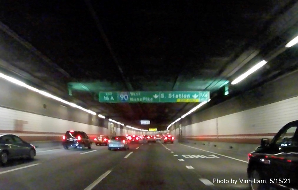 Image of 1/4 mile advance tunnel ceiling mounted exit only lane sign for I-90/South Station exit with new milepost based exit number on I-93 South in Boston, by Vinh Lam, May 2021 