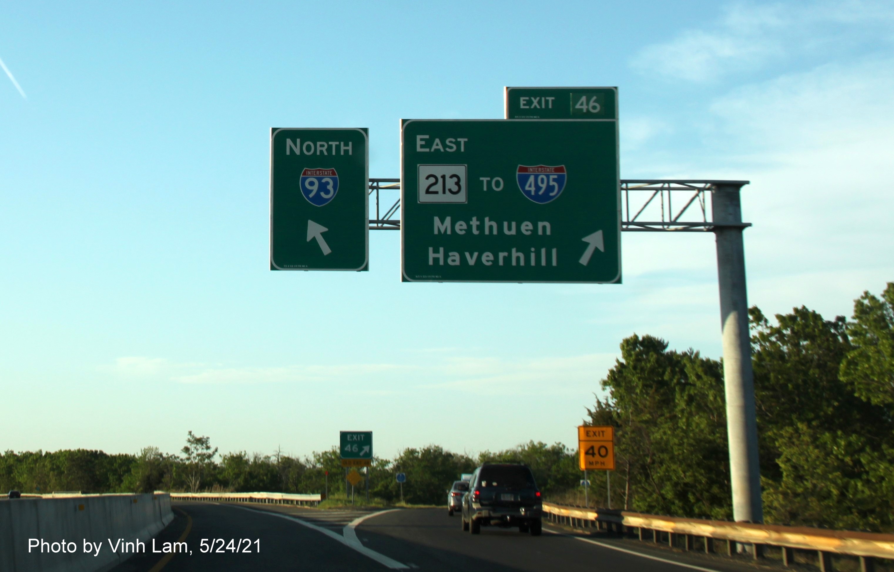 Image of overhead ramp signage for MA 213 exit with new milepost based exit number C/D ramp from I-93 North in Methuen, by Vinh Lam, May 2021
