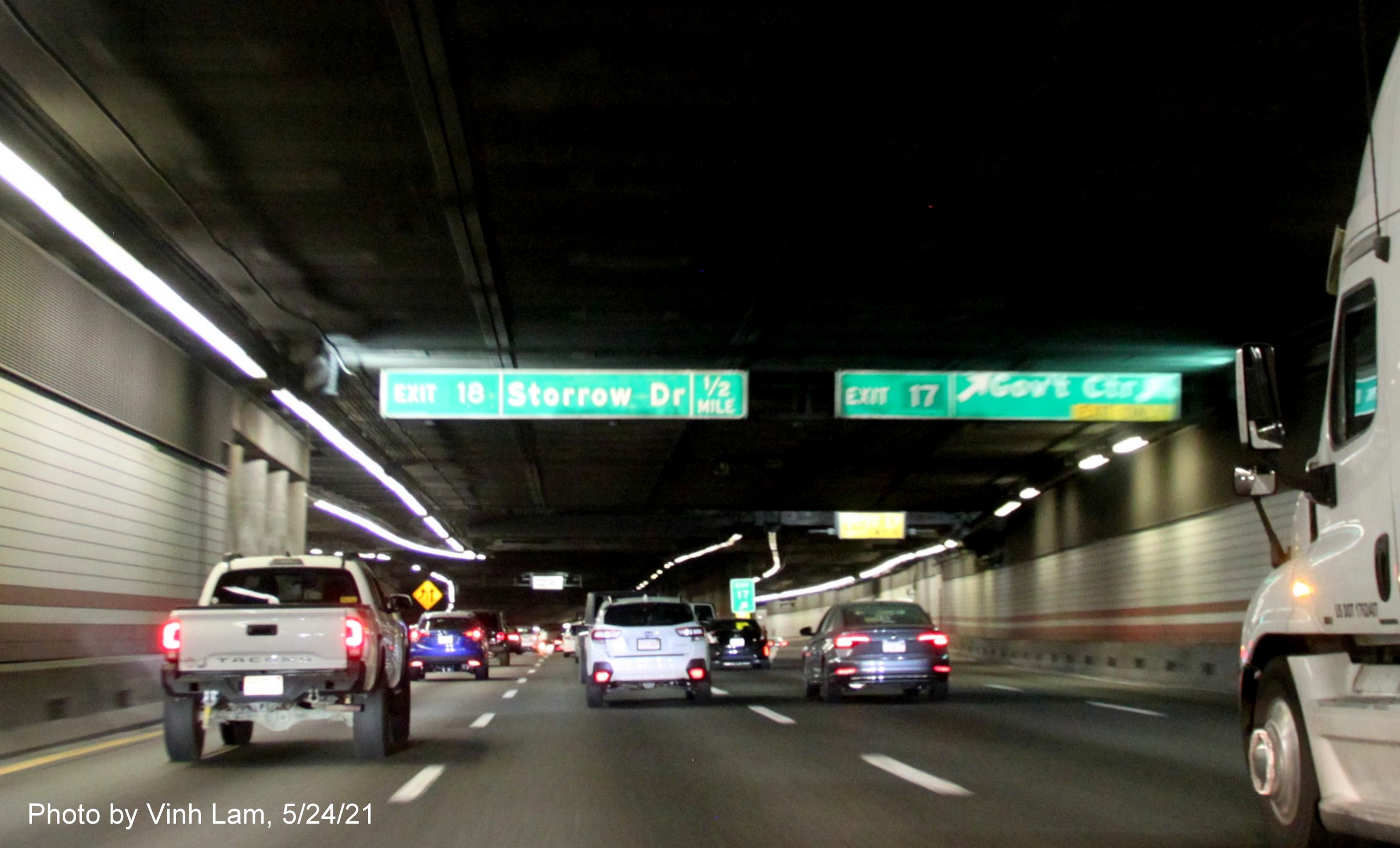 Image of overhead advance signs for Government Center and Storrow Drive exits with new milepost based 
      exit numbers on I-93 North in Boston, by Vinh Lam, May 2021