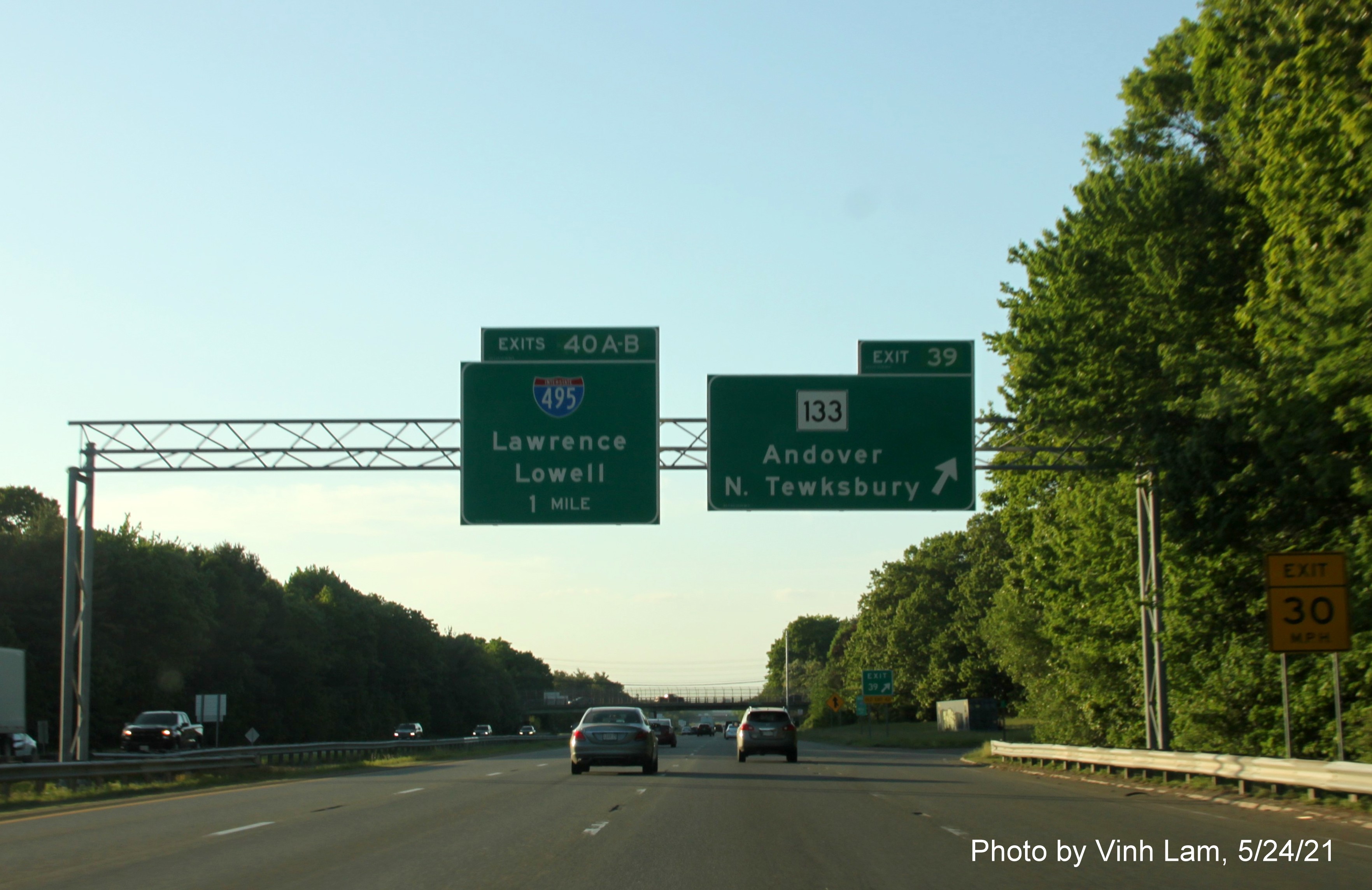Image of overhead ramp sign for MA 133 East exit with new milepost based exit number on I-93 North in Andover, by Vinh Lam, May 2021