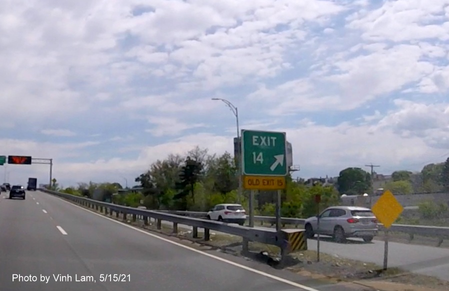 Image of gore sign for Columbia Road exit with new milepost based exit number and yellow Old Exit 15 sign attached below on I-93/Southeast Expressway South in South Boston, by Vinh Lam, May 2021