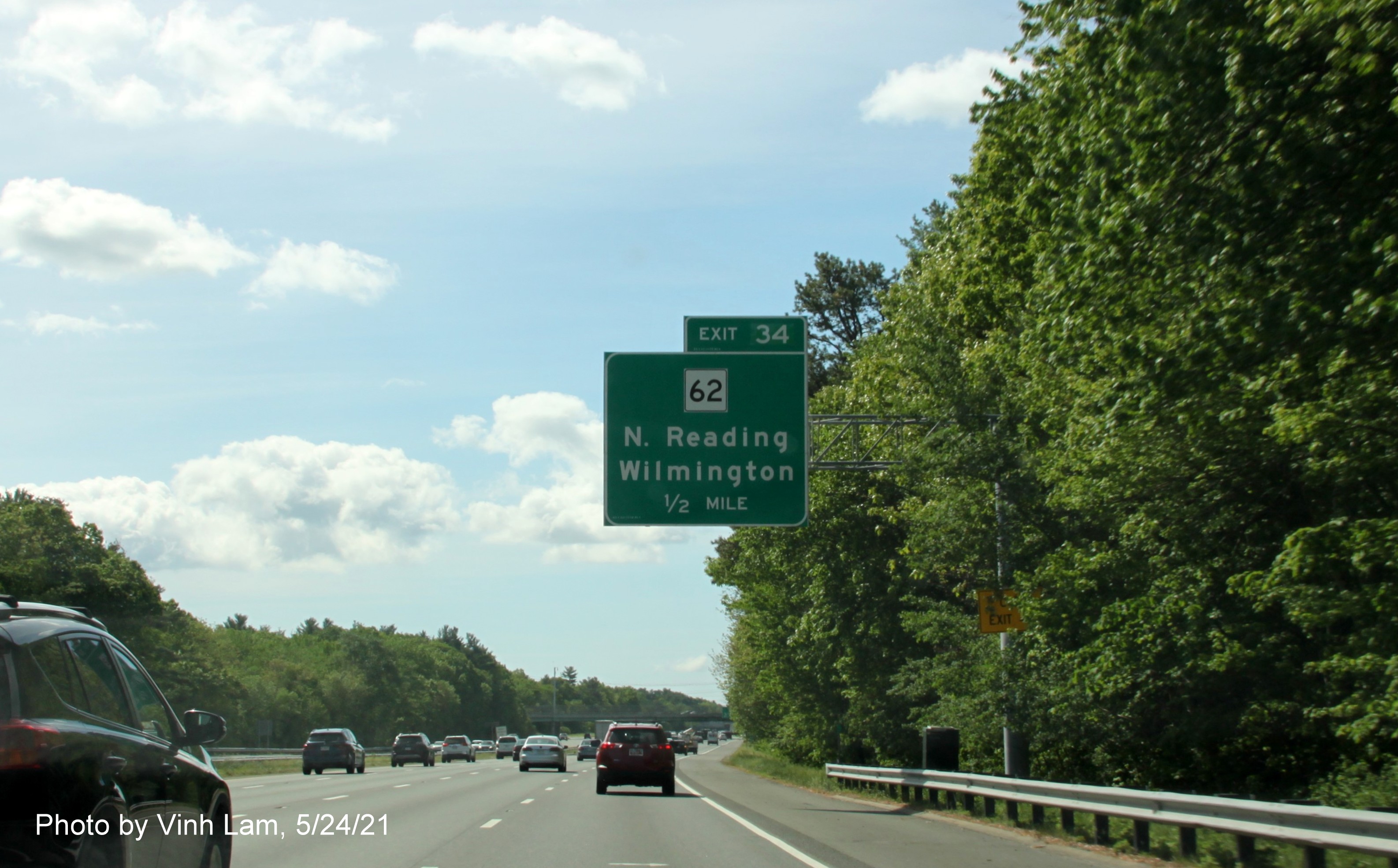 Image of 1/2 Mile advance overhead sign for MA 62 exit with new milepost based exit number and yellow Old Exit 40 advisory sign on support on I-93 South in Wilmington, by Vinh Lam, May 2021