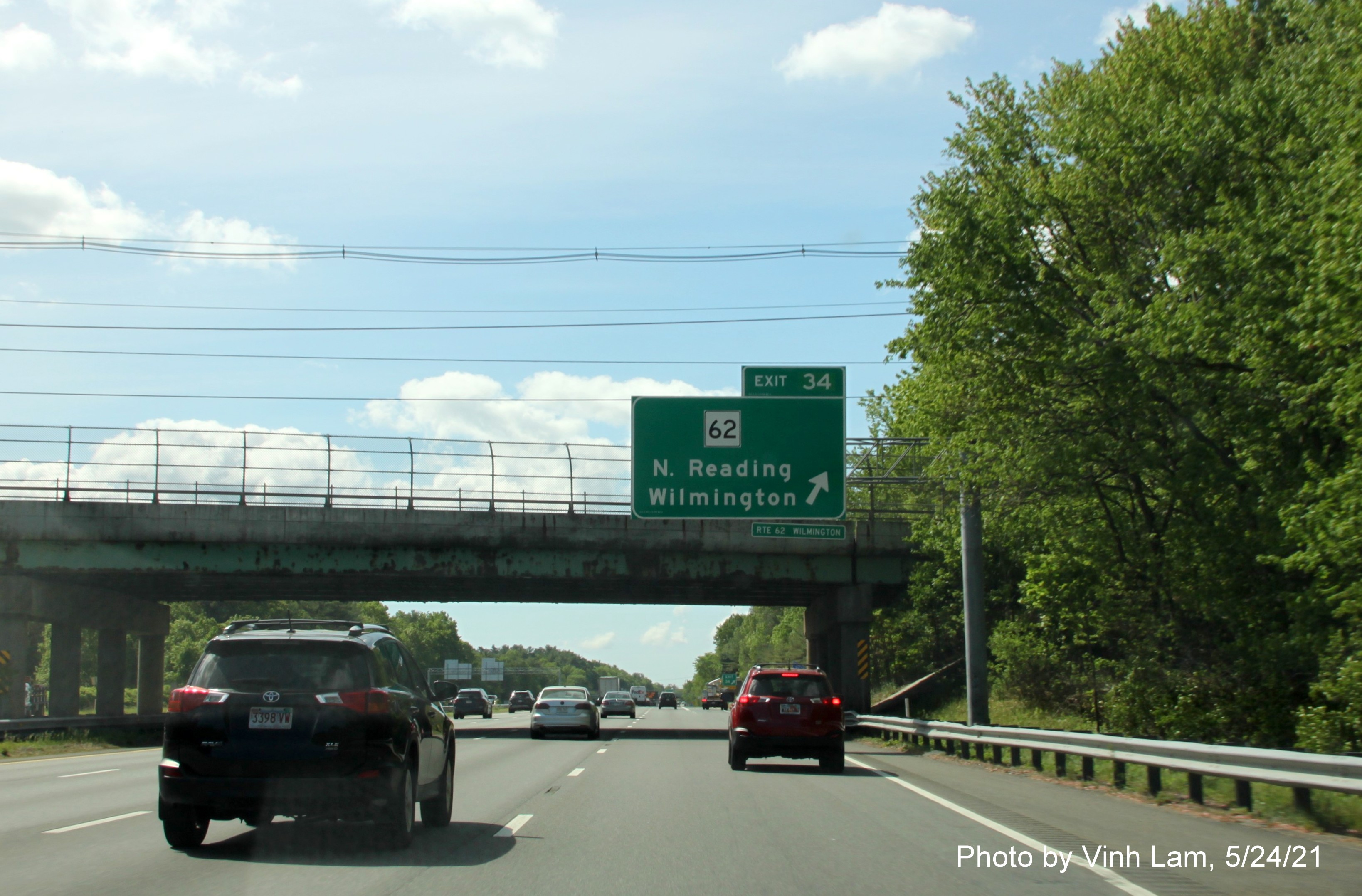 Image of overhead ramp sign for MA 62 exit with new milepost based exit number I-93 South in Wilmington, by Vinh Lam, May 2021