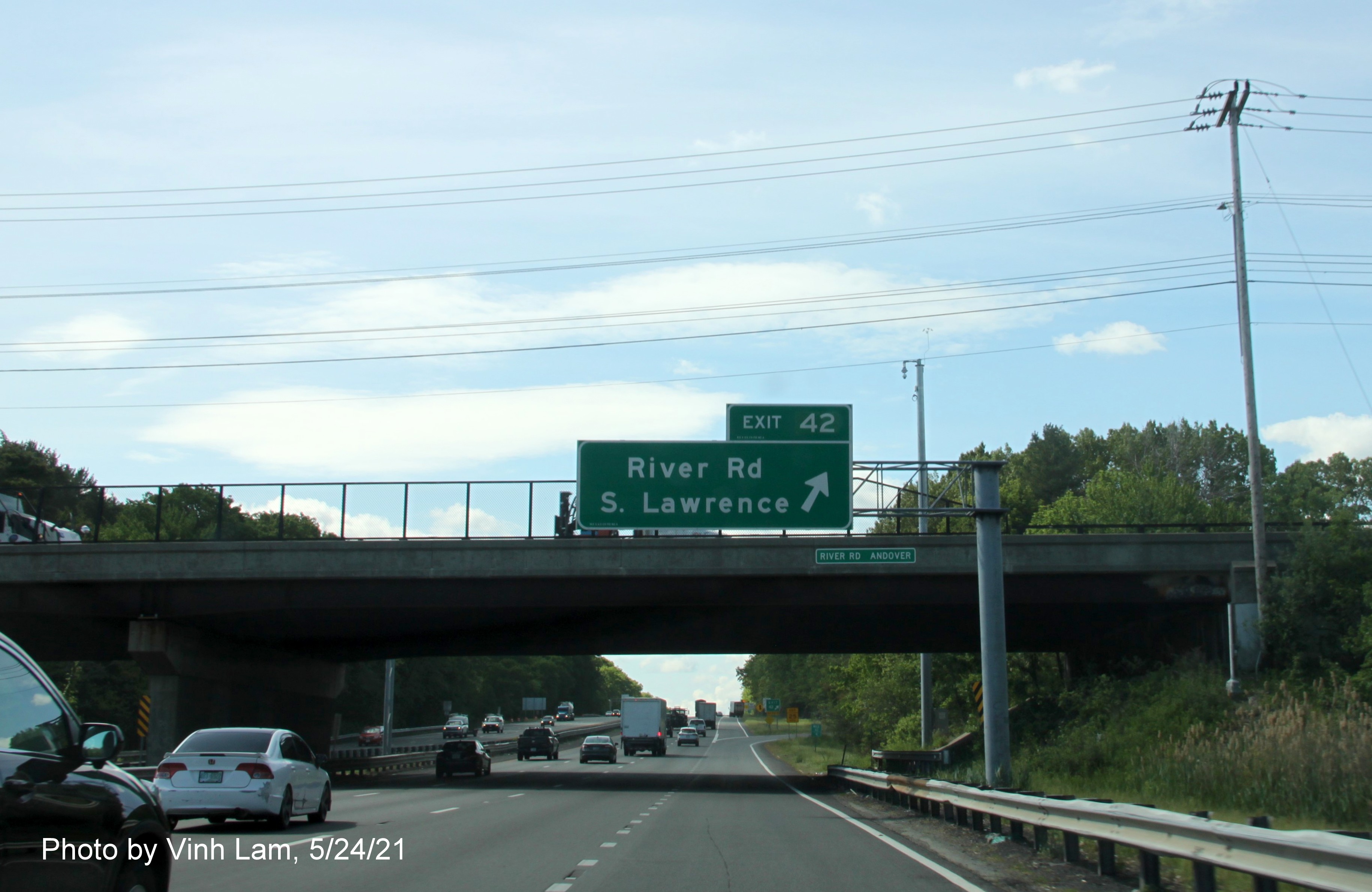 Image of overhead ramp sign for River Road exit with new milepost based exit number on I-93 South in Andover, by Vinh Lam, May 2021