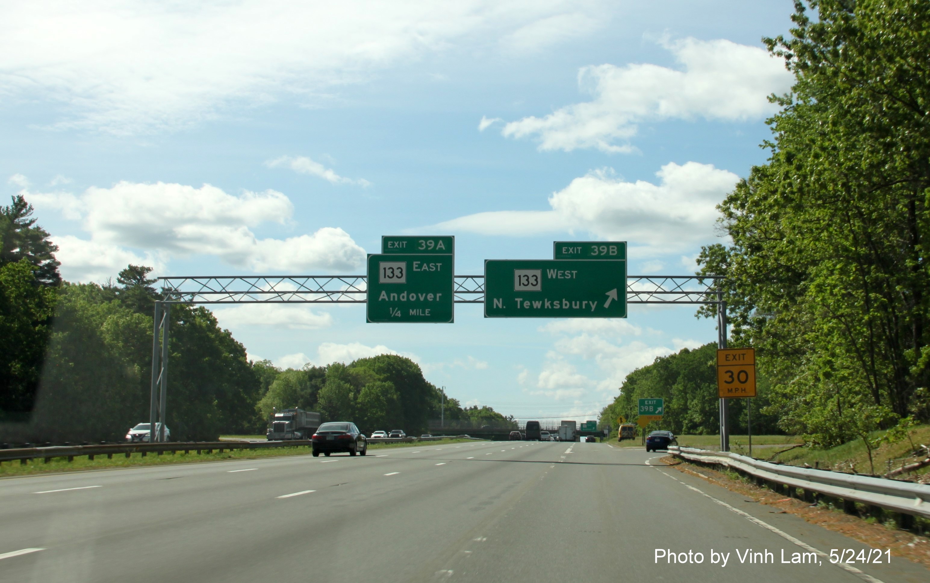 Image of overhead signage at ramp for MA 133 West exit with new milepost based exit numbers on I-93 South in Andover, by Vinh Lam, May 2021